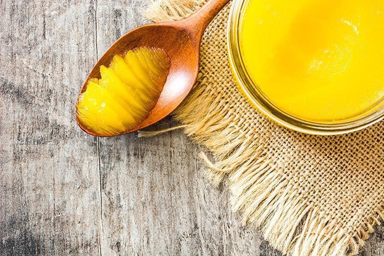 23 Best Keto Condiments You Must Try A jar of butter with a spoon of ghee