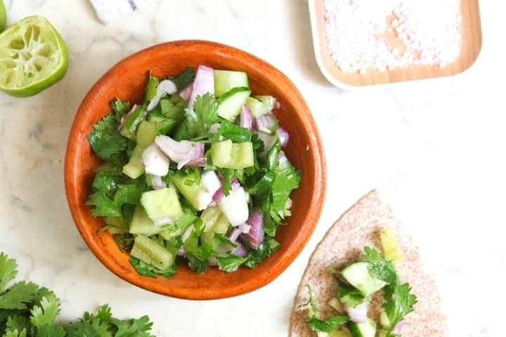 Bowl of keto cucumber salsa with onion and cilantro