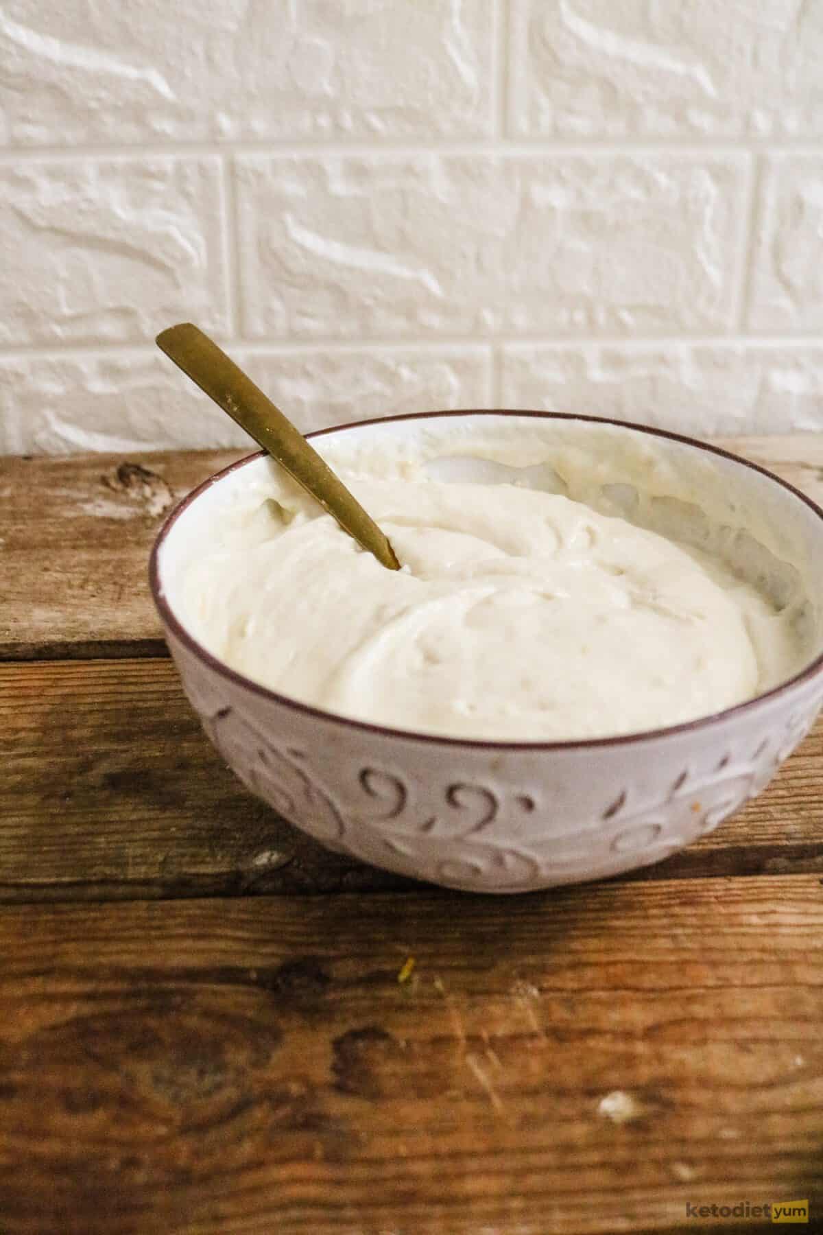A mixing bowl of cream cheese filling made with cream cheese, vanilla extract, egg, almond flour, Erythritol and lemon zest