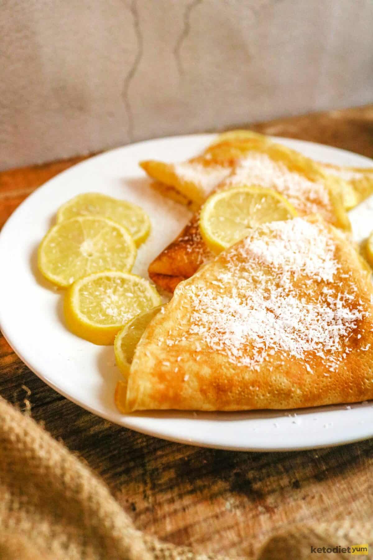 Coconut flour crepes with lemon and coconut flakes