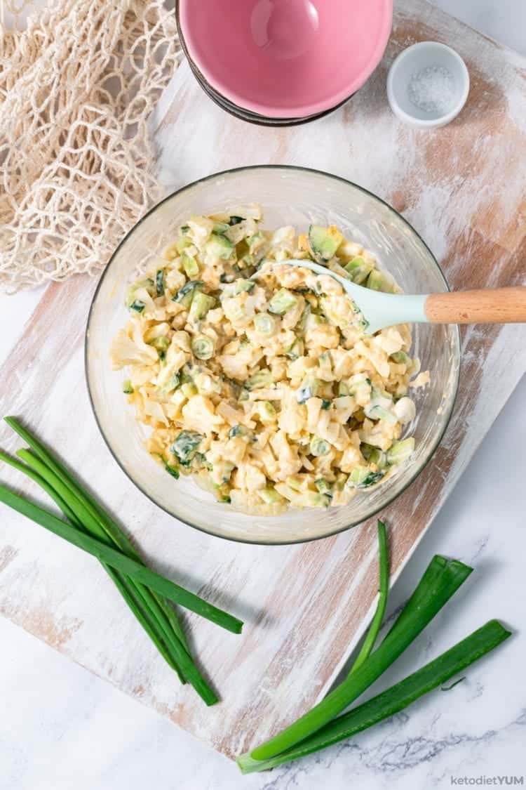 combining ingredients for a delicious keto cauliflower salad