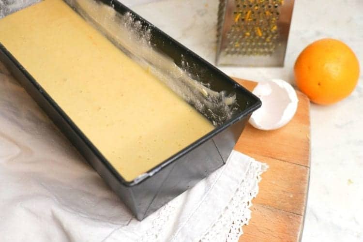 Orange cake batter in loaf pan ready to bake