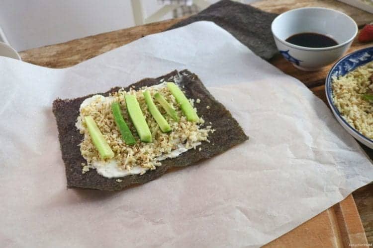 nori sheet with cream cheese, cauliflower rice, avocado and cucumber slices