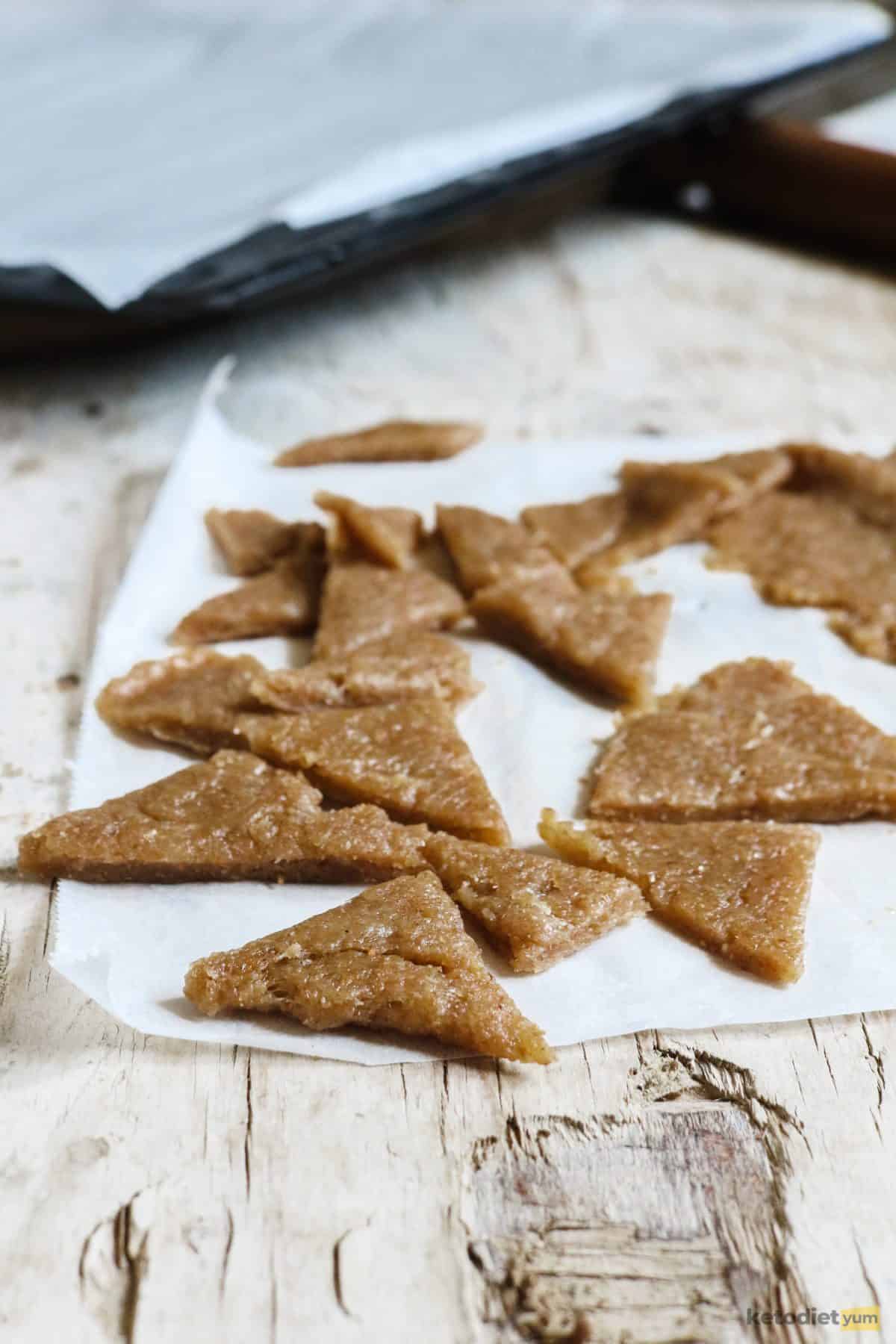 Cutting low carb tortilla chip dough into triangle chips ready to bake