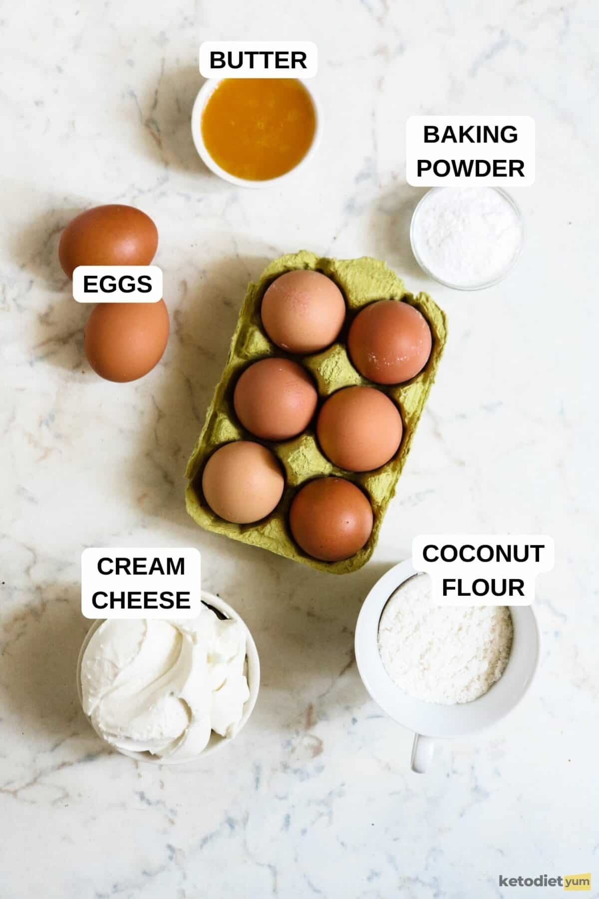 Eggs in a carton and small bowls filled with various ingredients on a table