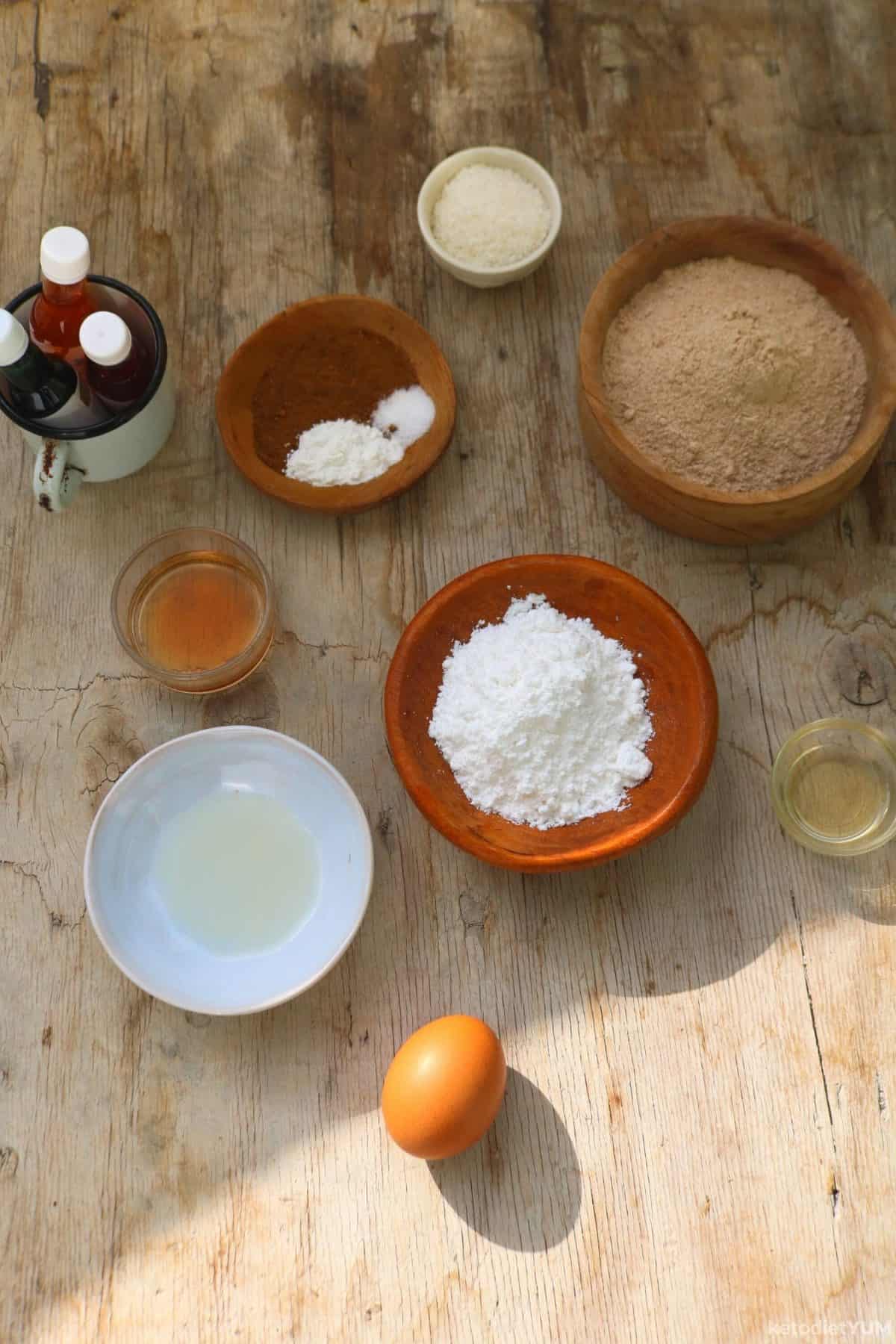 Different ingredients to make cookies in bowls on a table