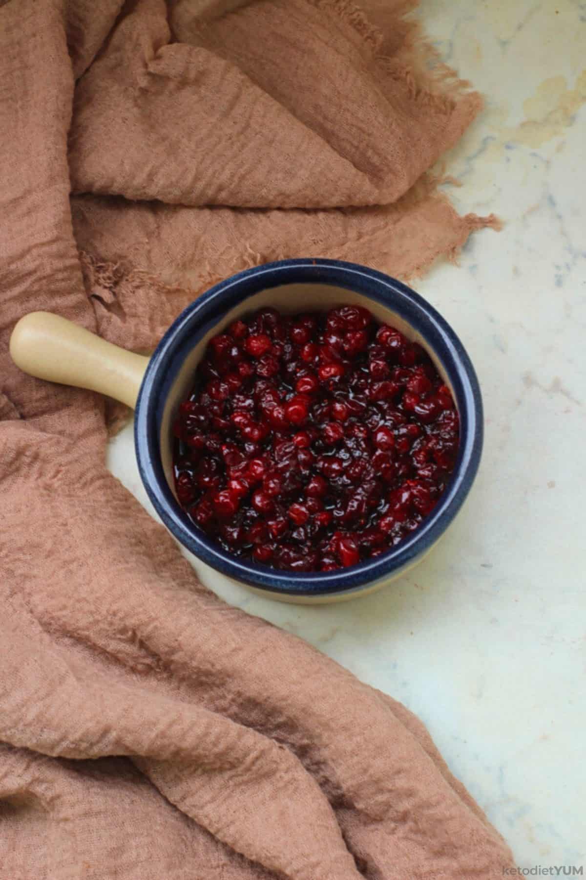 Delicious keto cranberry sauce in a saucepan ready to enjoy