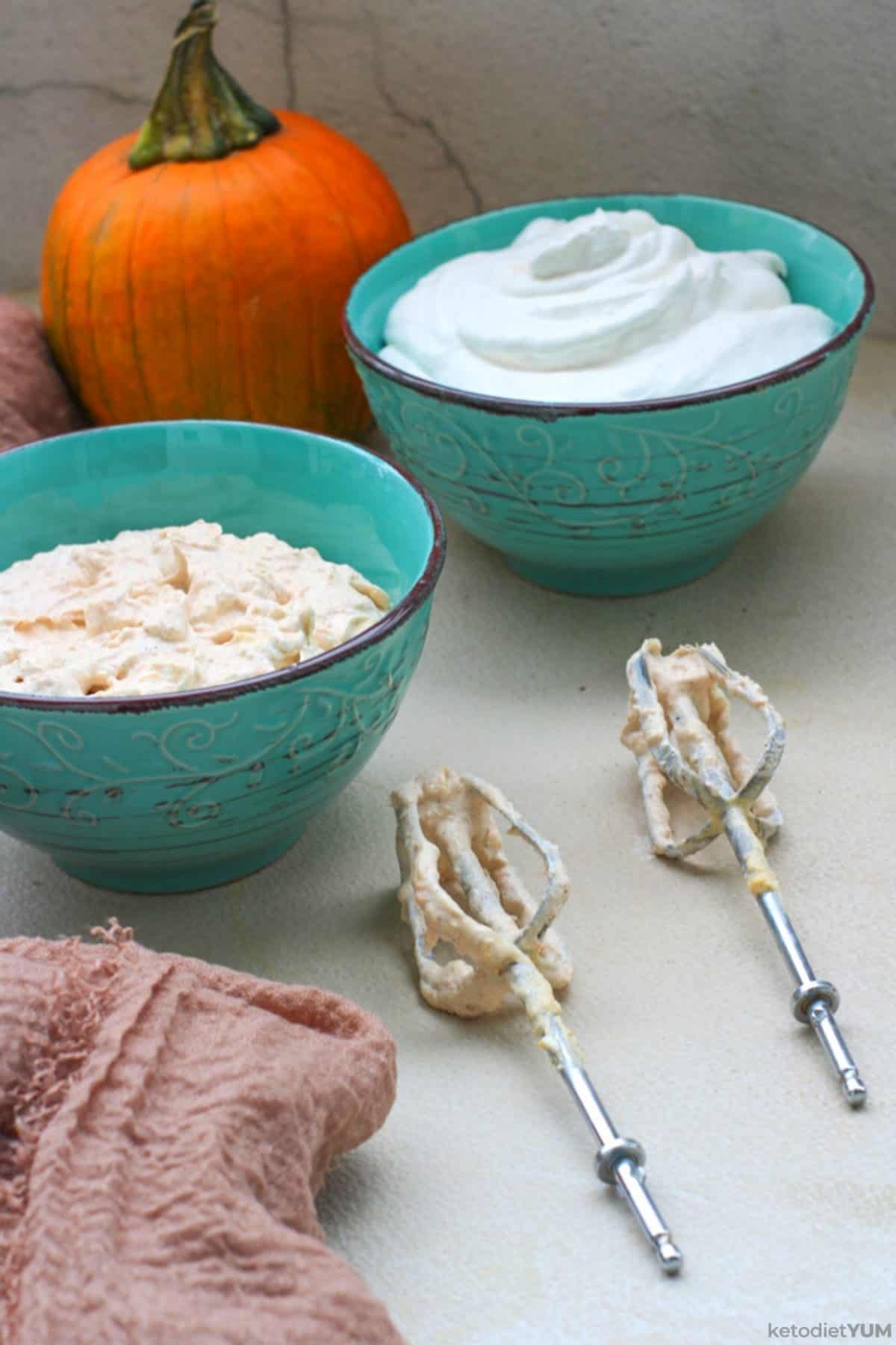 Beating the heavy cream and cream cheese mixtures with an electric blender