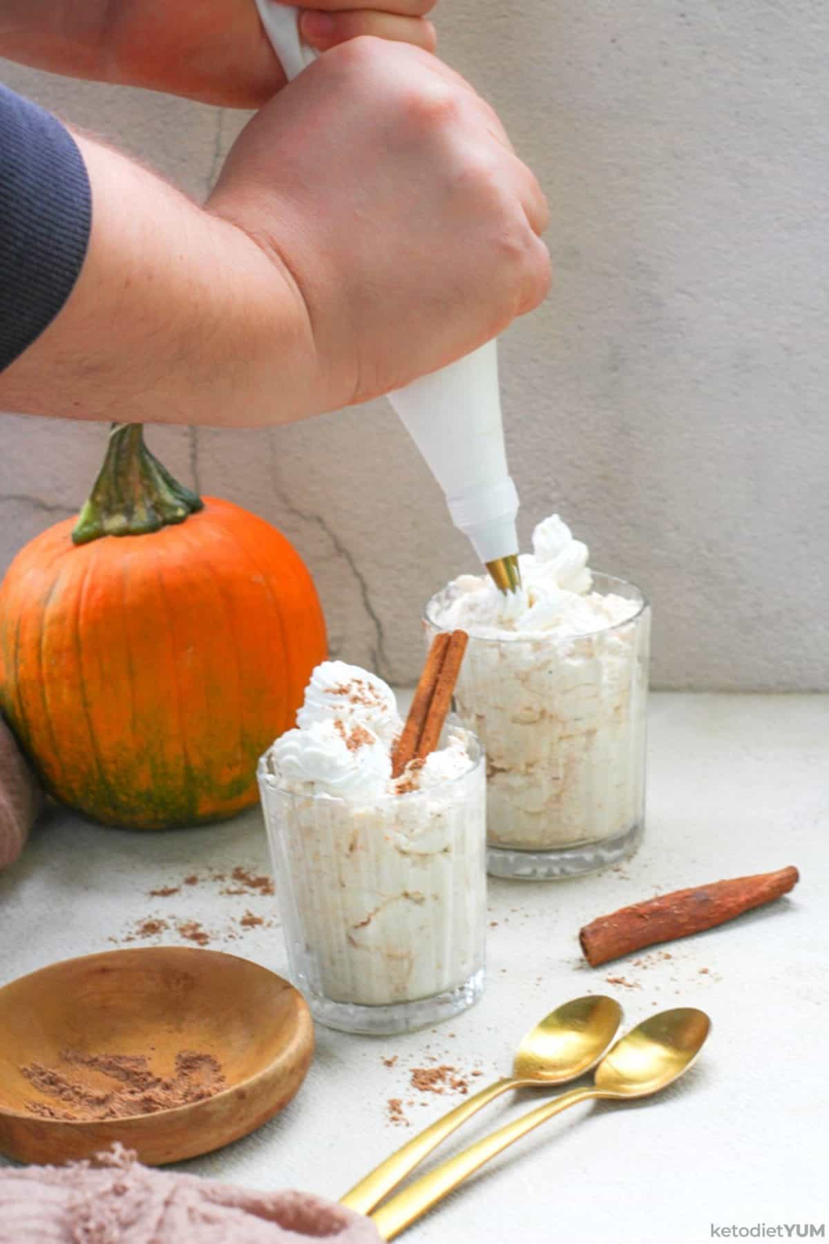 Piping the low carb pumpkin mousse into glasses ready to place in the refrigerator to set overnight