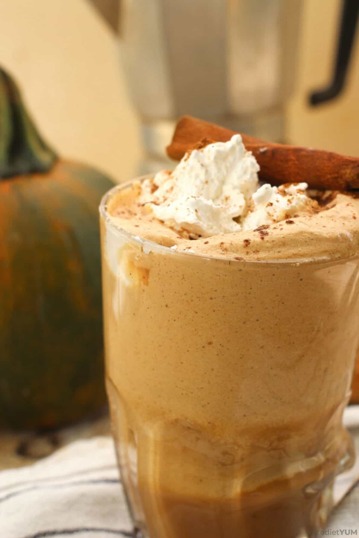 Delicious keto pumpkin spice latte topped with whipped cream, pumpkin spice and cinnamon
