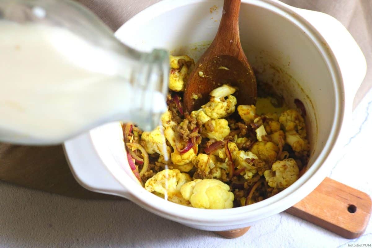 Adding coconut milk to the ground beef cauliflower curry