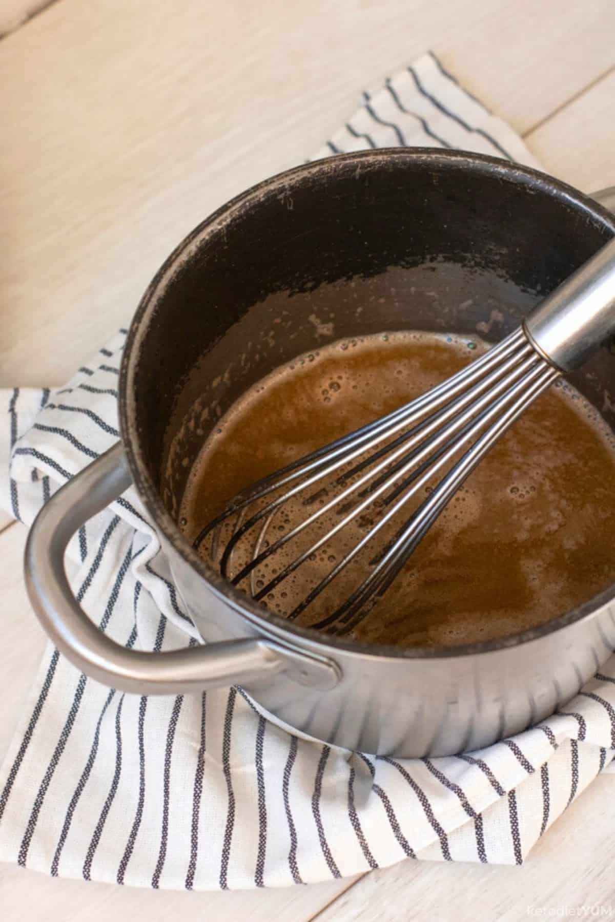 Whisking together the ingredients for a hot buttered rum that is super low in carbs!