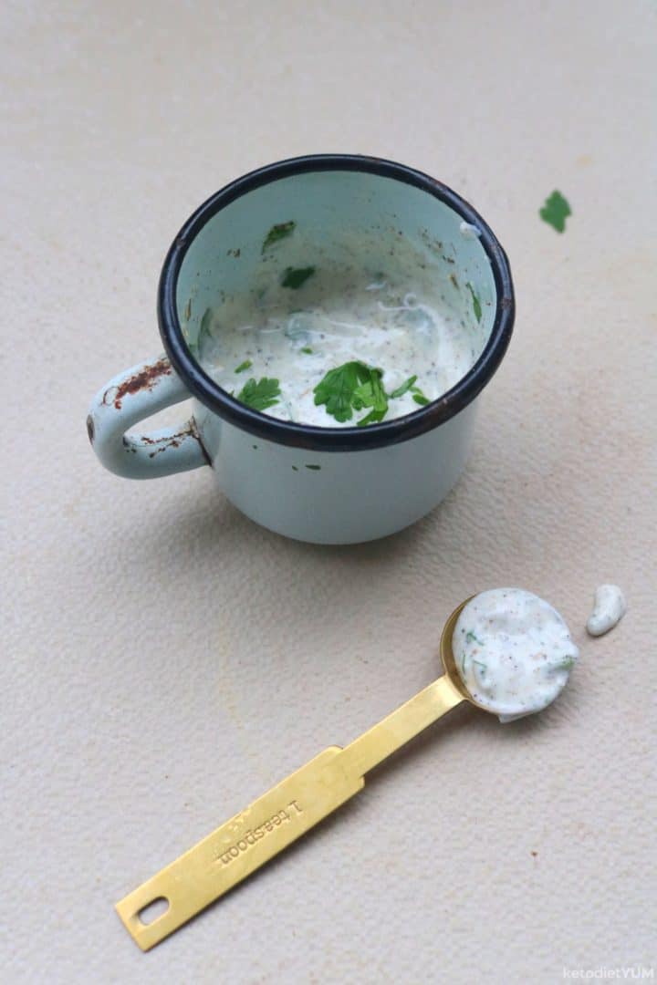 Making a homemade salad dressing with mayonnaise, milk, dill, parsley, garlic powder, salt and black pepper