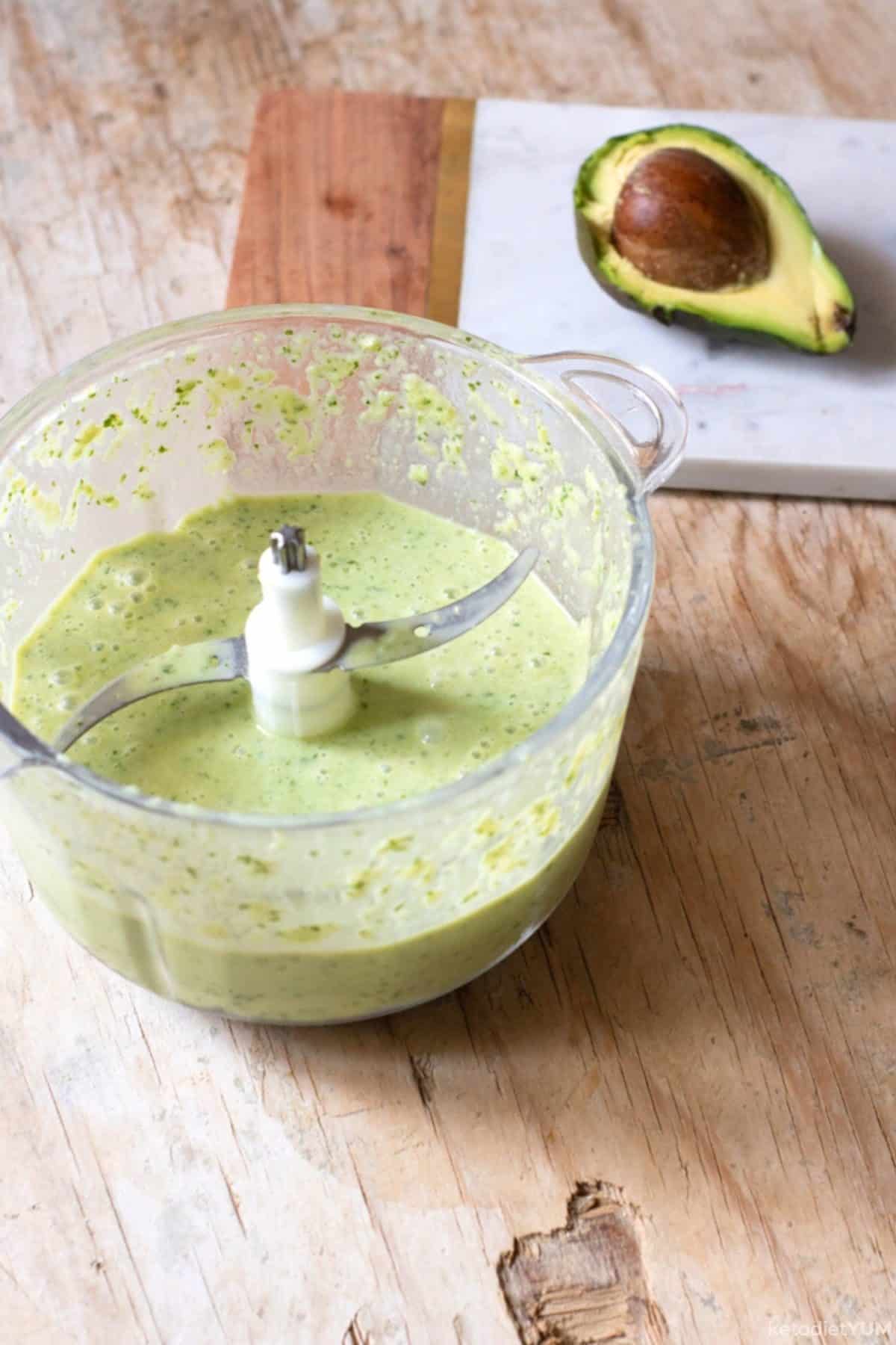 Adding all the ingredients to a blender to make a keto kale smoothie