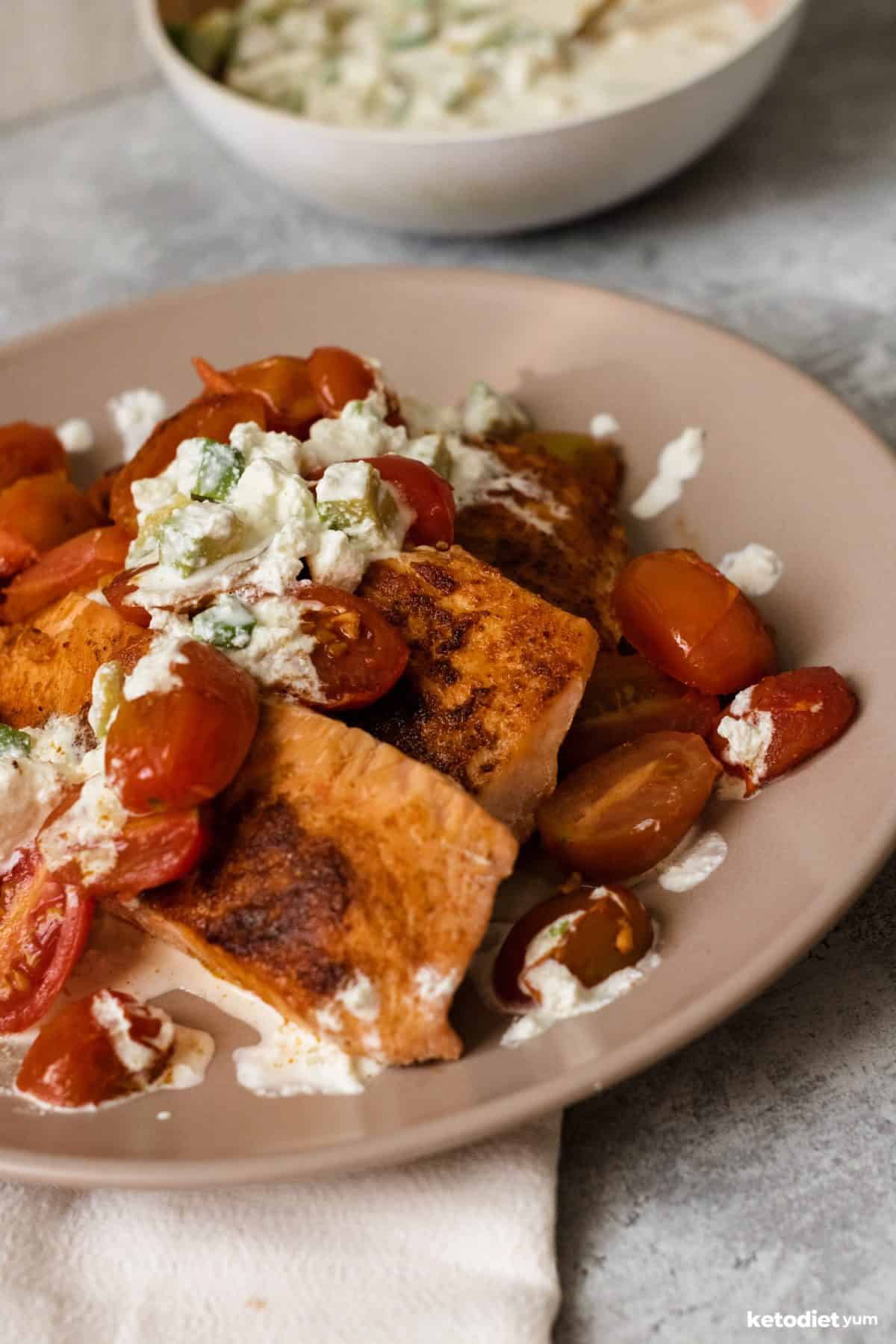 Delicious pan seared salmon with cherry tomatoes and a goat cheese sauce