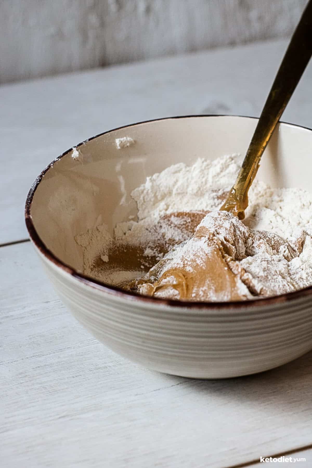 Mixing together peanut butter, coconut flour and sugar-free maple syrup to make peanut butter energy ball batter