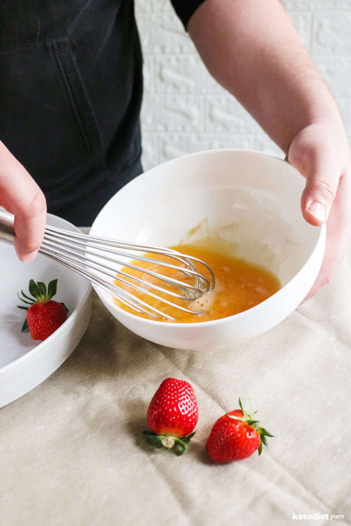 Whisking eggs, Erythritol and vanilla extract in a mixing bowl