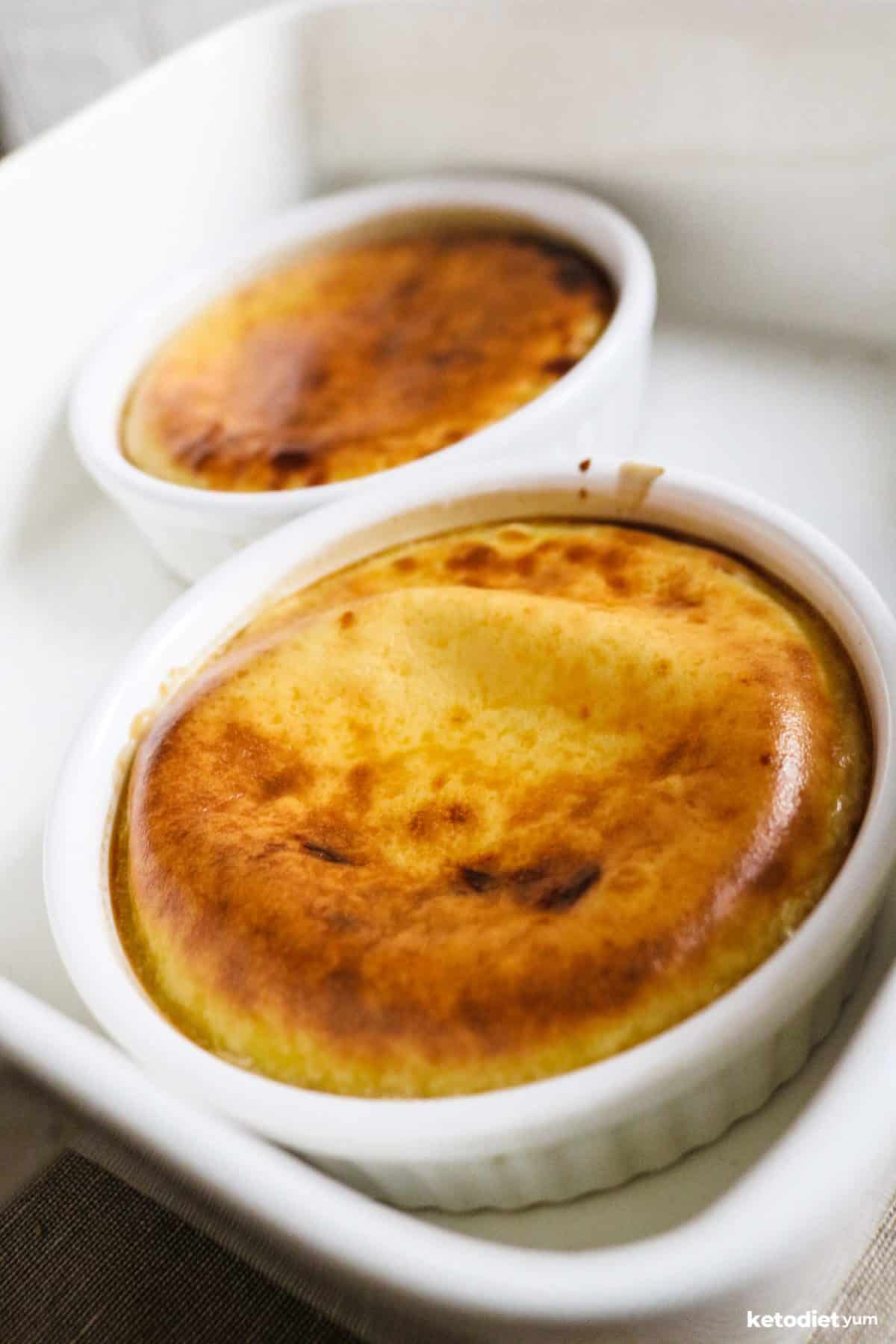 Ramekins filled with keto custard that has a golden brown top