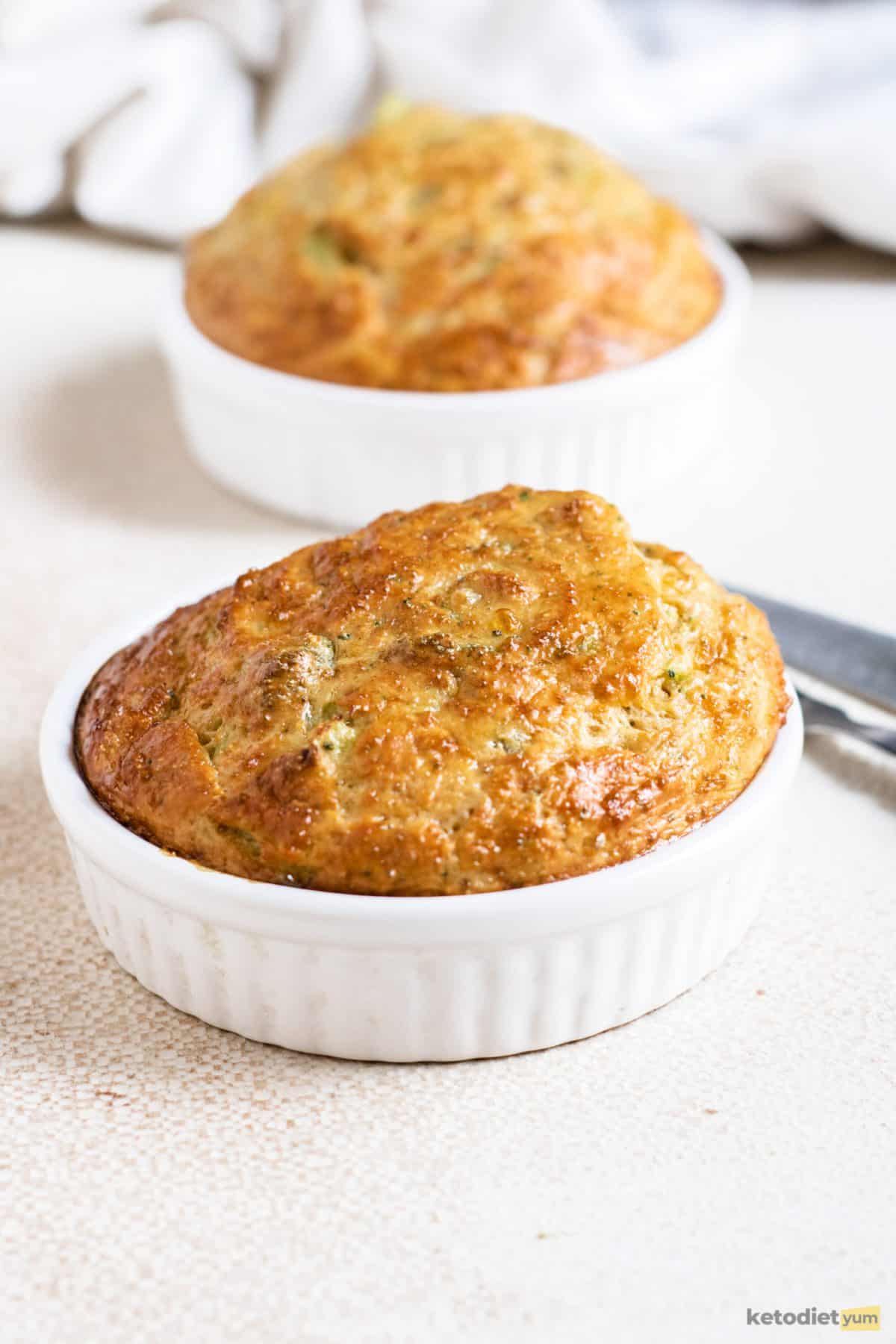 A golden broccoli quiche in a ramekin fresh out of the oven and ready to enjoy