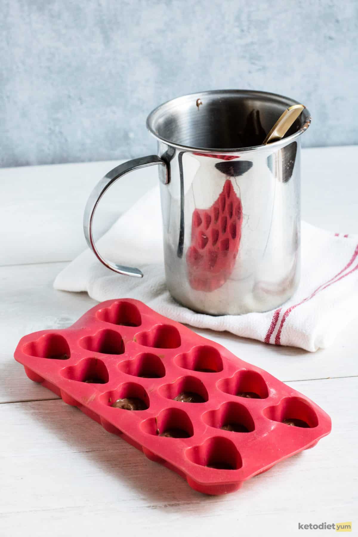 3 Ingredient Keto Chocolate Hearts A double boiler and heart-shaped silicone tray