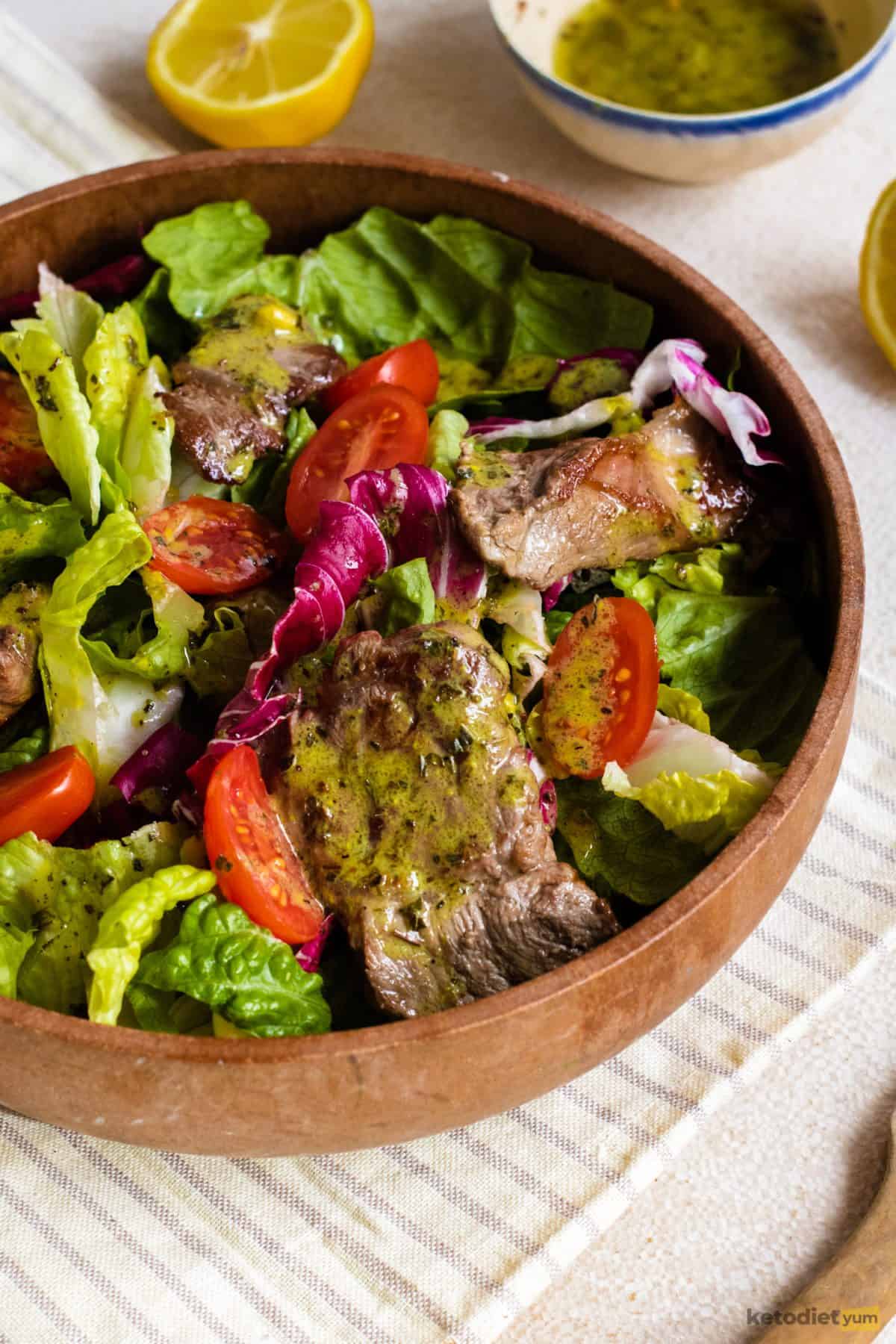 Keto steak salad finished and served in a brown bowl