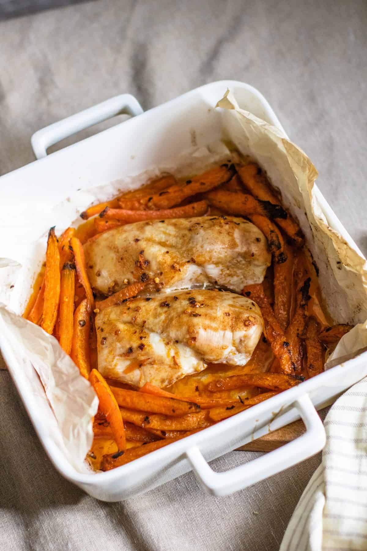 Chicken breasts and sliced carrots baked to perfection in an oven dish