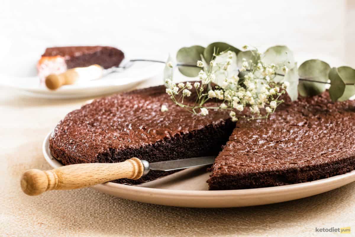 Chocolate keto pie on a serving plate with a knife