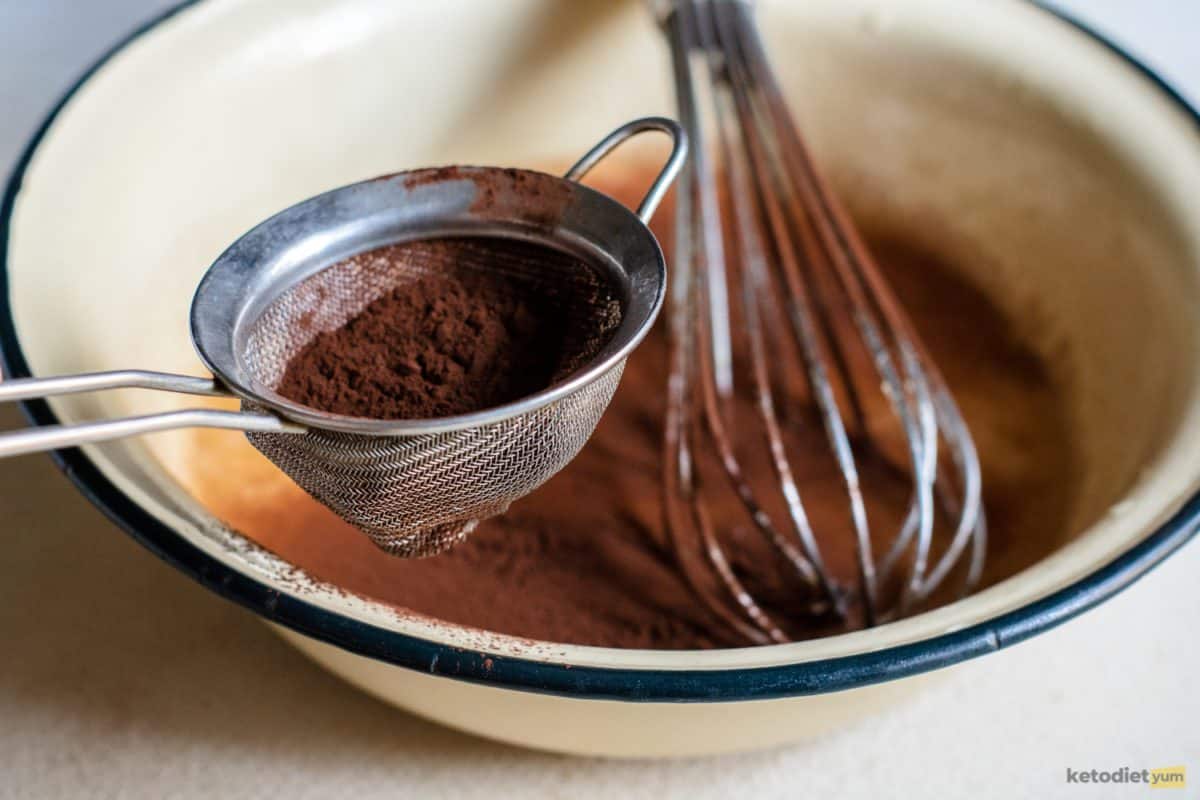 Mixing together cocoa powder, Erythritol, almond flour, baking powder and salt in a mixing bowl