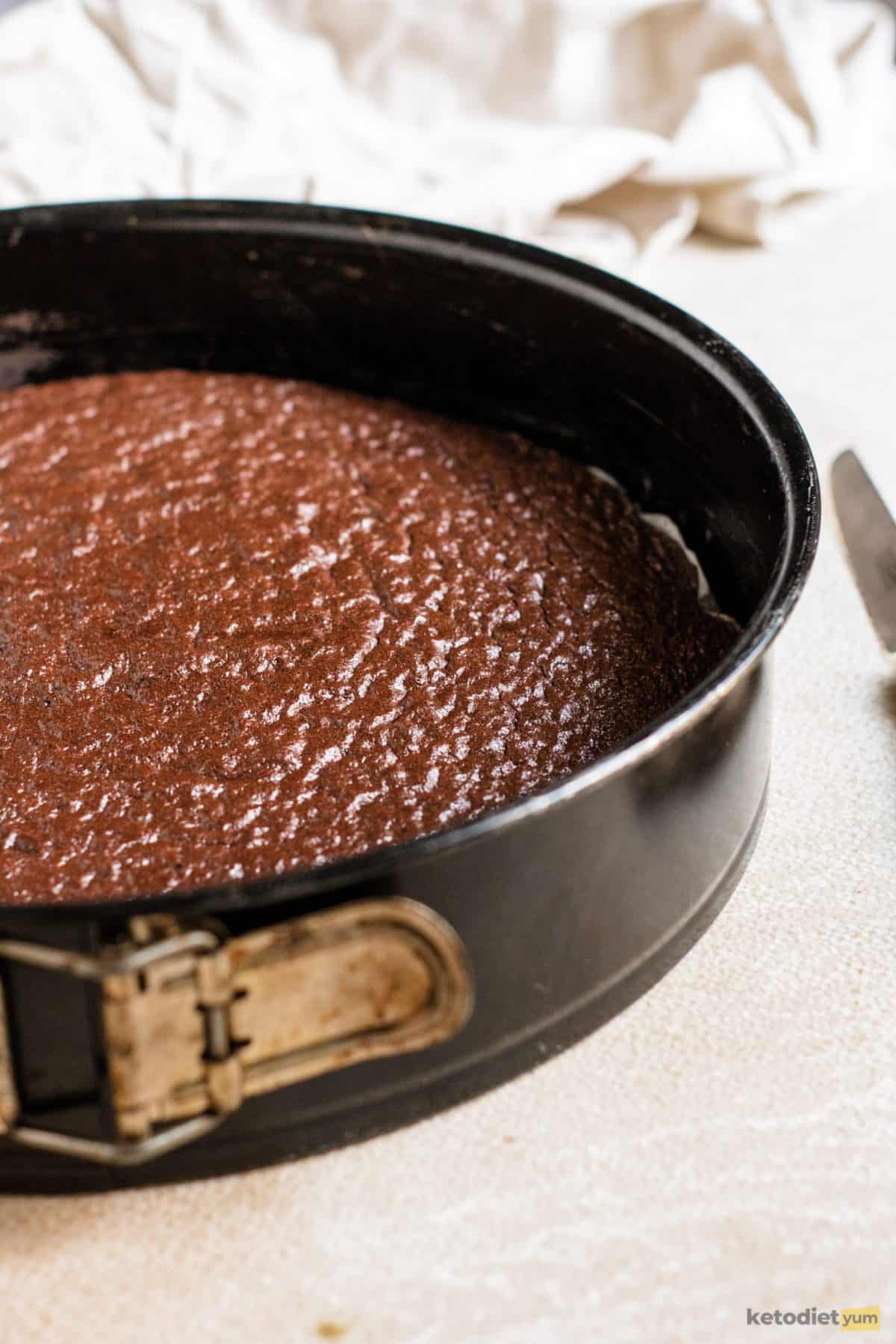 Keto chocolate pie fresh out of the oven in an 8 inch cake pan