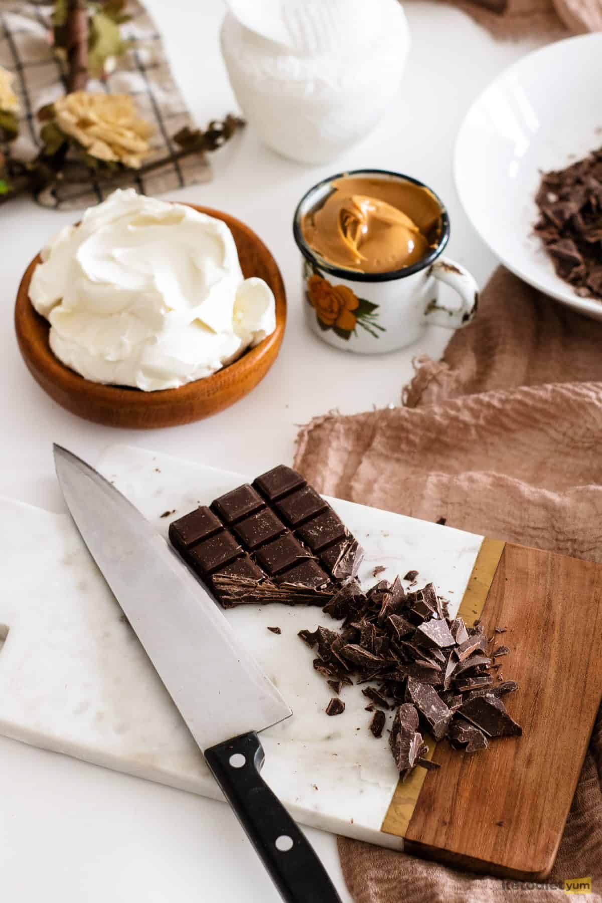 Ingredients on a table needed to make keto chocolate peanut butter Easter eggs