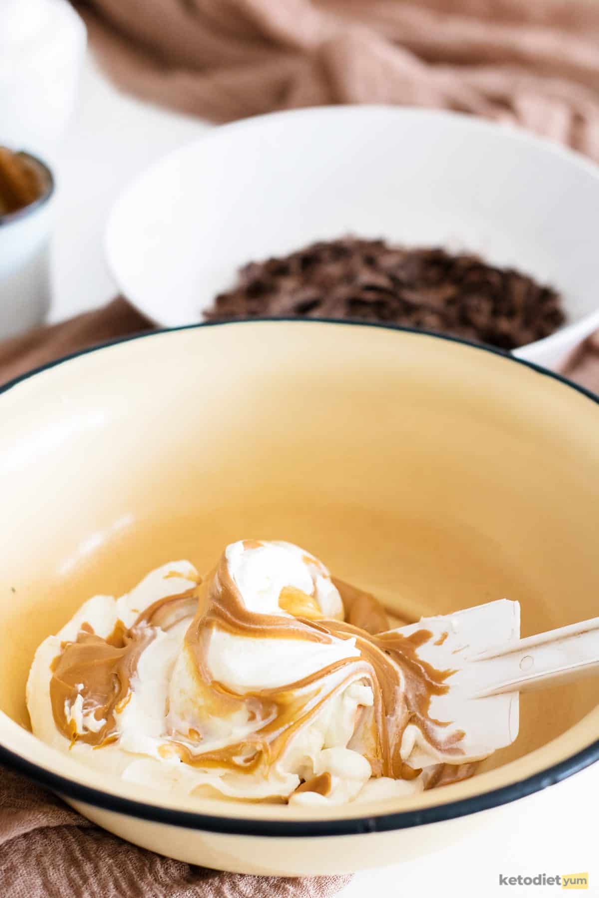 A mixing bowl with cream cheese, peanut butter and a pinch of salt as the filling for keto Easter eggs