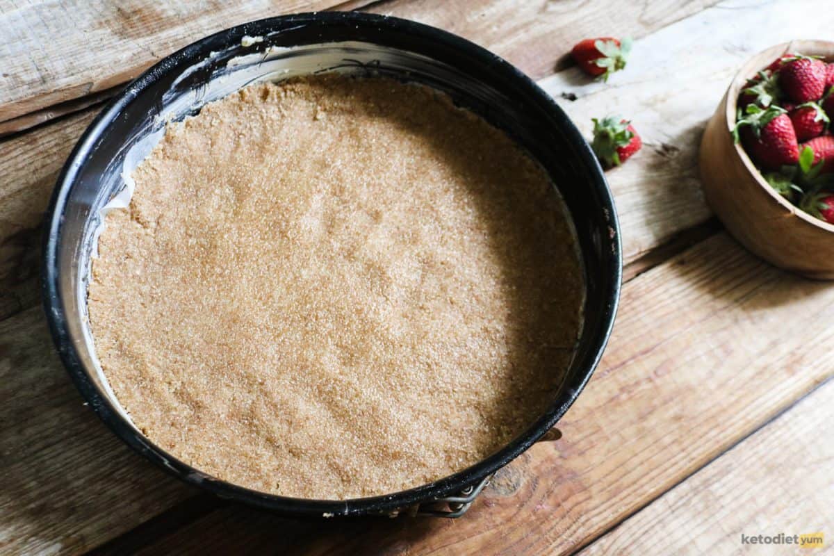 Transferring the cream cheese tart base to a lined and greased baking pan