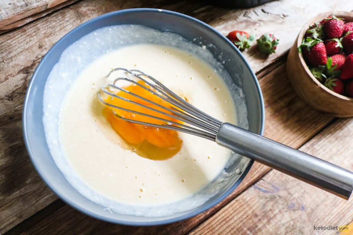 Mixing cream cheese, Erythritol, sour cream, lemon zest, vanilla extract, eggs and almond flour to create the tart filling