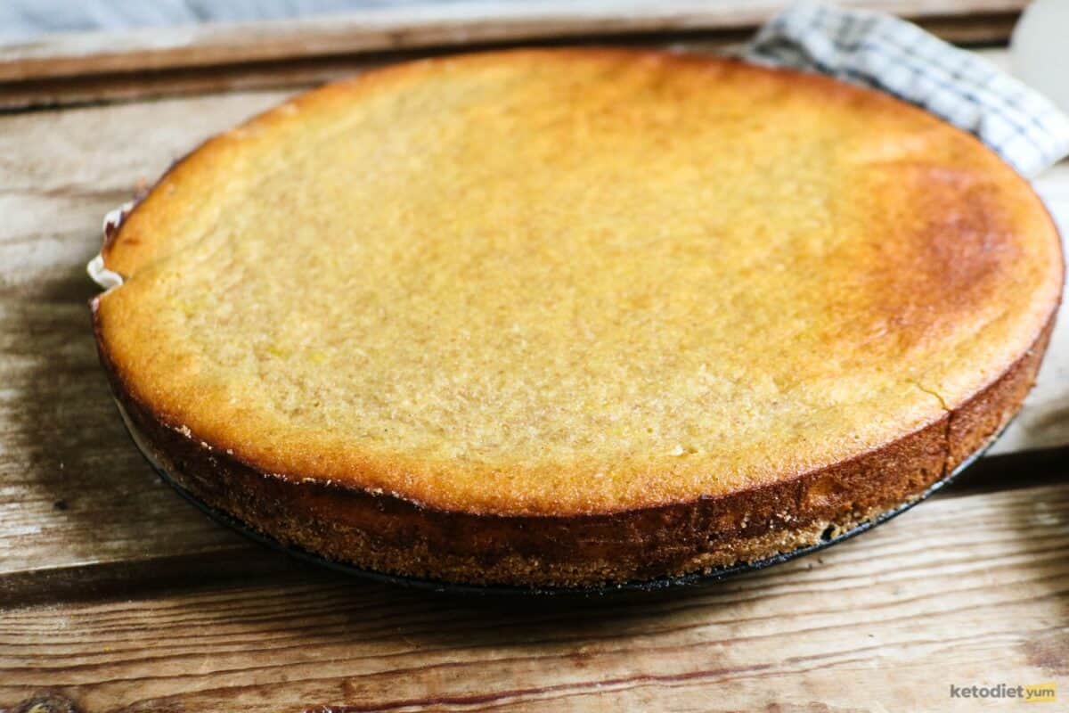 A low carb cream cheese tart with golden sides and springy center fresh out of the oven cooling on a table