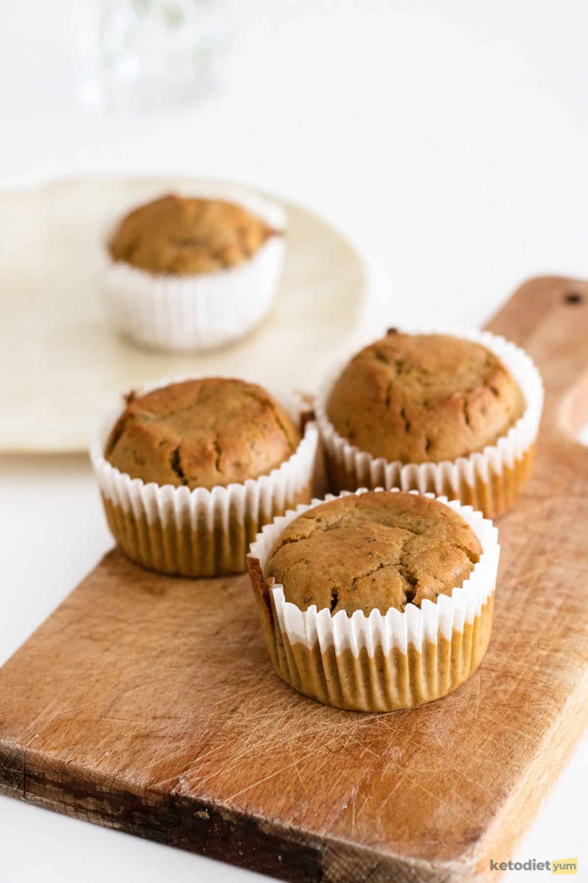 Fresh matcha cupcakes out of the oven on a wooden tray