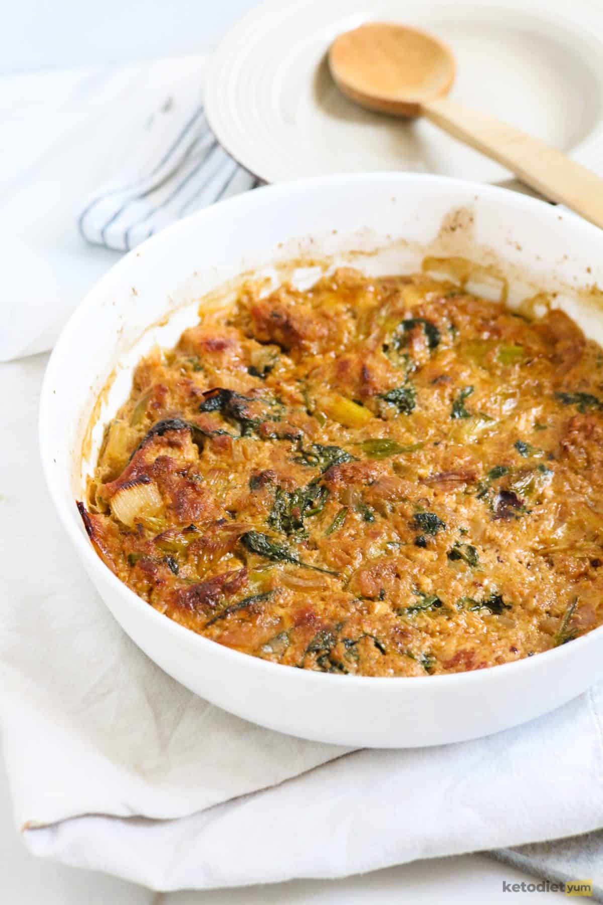 A healthy keto chicken casserole in an oven dish ready to slice and serve