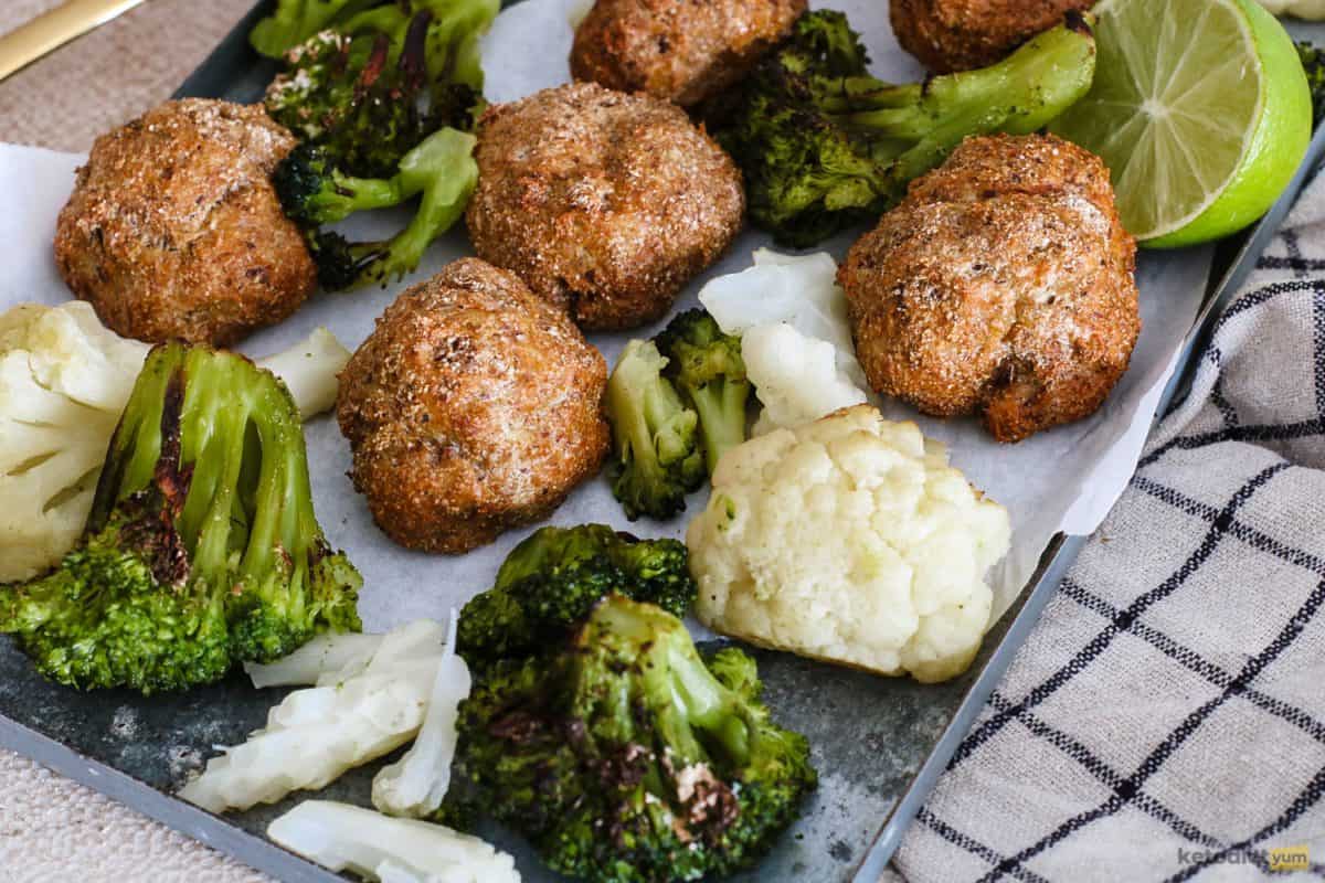 Perfectly golden keto chicken meatballs with roast broccoli and cauliflower made on one oven tray
