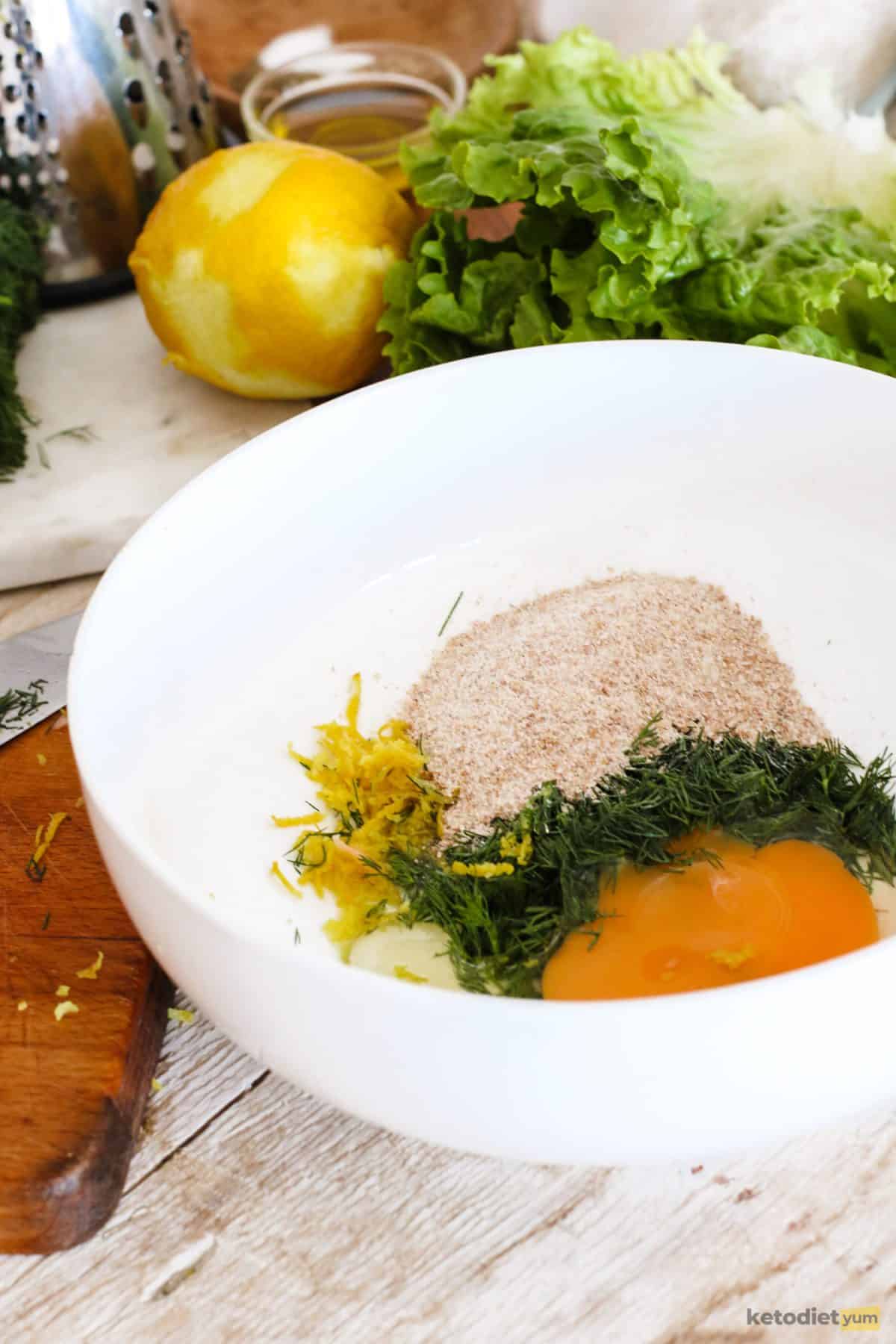 Combining ingredients in a bowl to make salmon burger patties