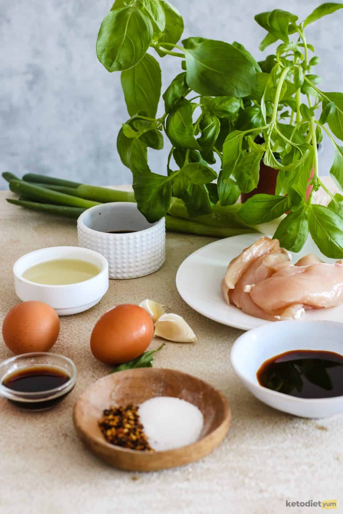 Ingredients arranged on a table to make low carb Thai basil chicken