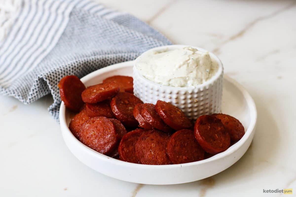 Delicious low carb baked chorizo chips with cream cheese dip are in a bowl