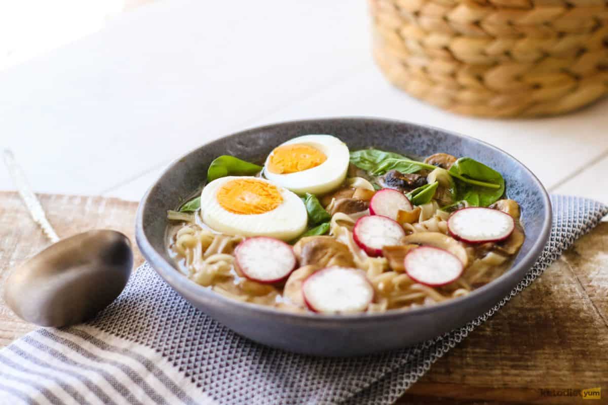 A delicious bowl of keto ramen soup topped with egg and thin slices of radish