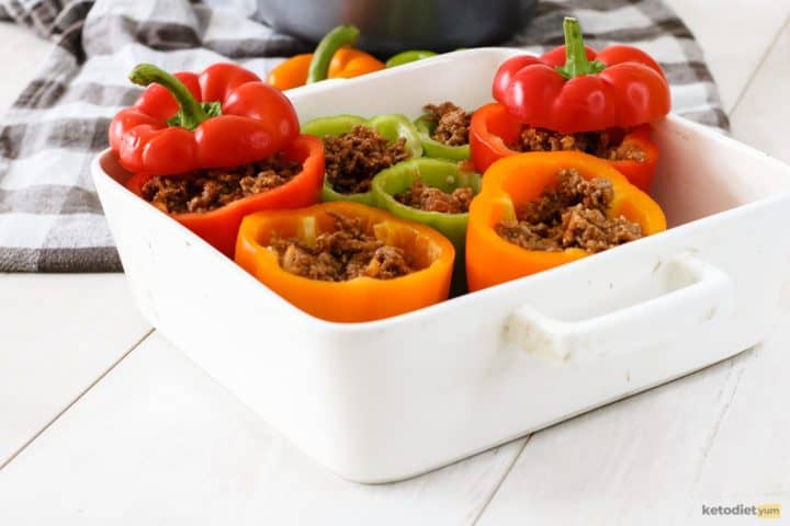 Halved bell peppers on a baking tray filled with ground beef mixture