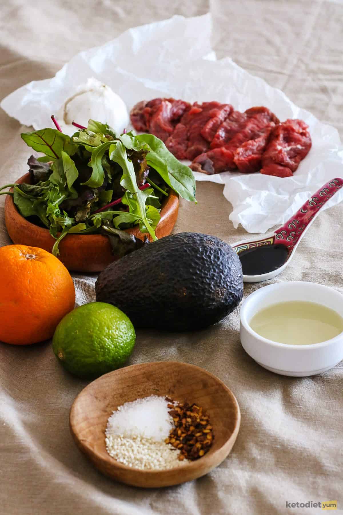 Ingredients arranged on a table to make a keto Korean BBQ Steak Salad