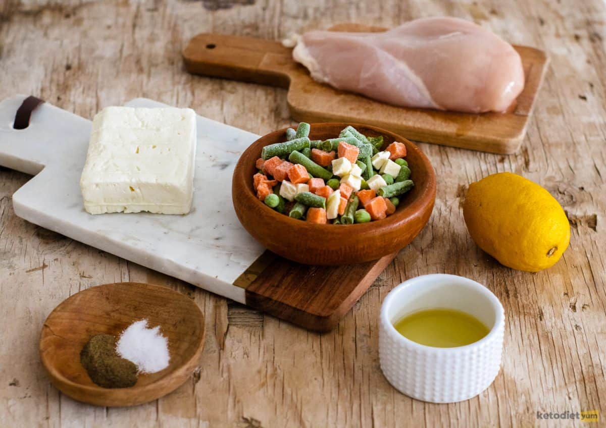 Ingredients arranged on a table to make roasted chicken and vegetables with feta cheese