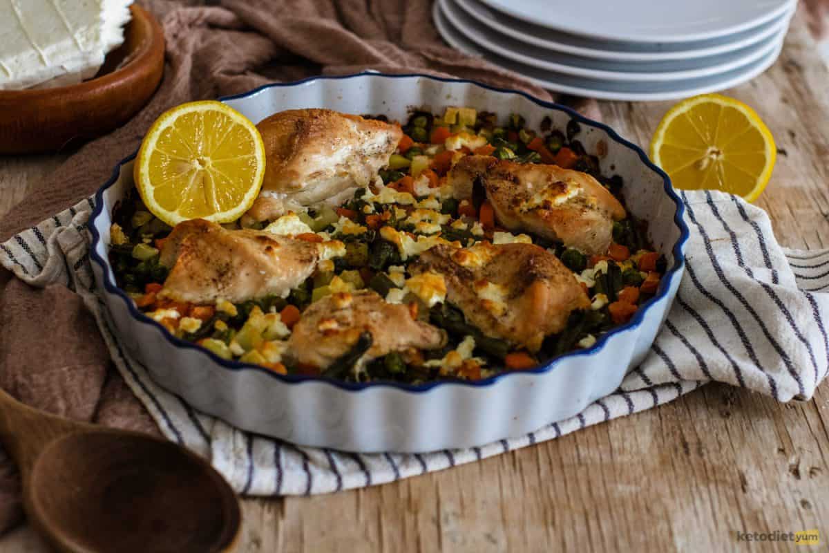 A delicious one tray dish of roasted chicken and vegetables topped with feta cheese and lemon