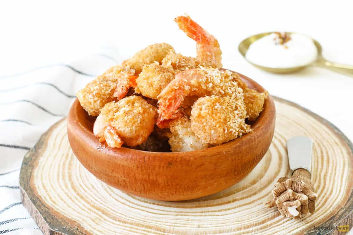 Perfectly crispy and tender coconut shrimp served in a brown bowl ready to enjoy