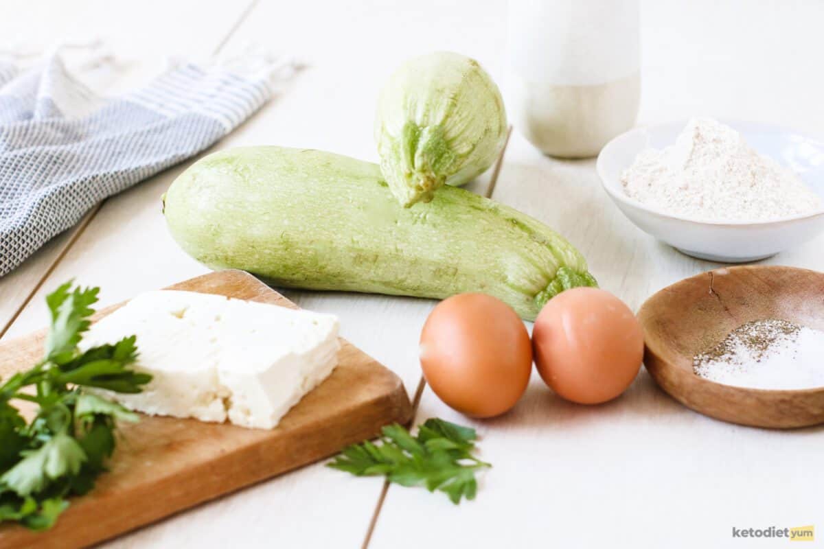 Ingredients arranged on a table used to make keto zucchini fritters