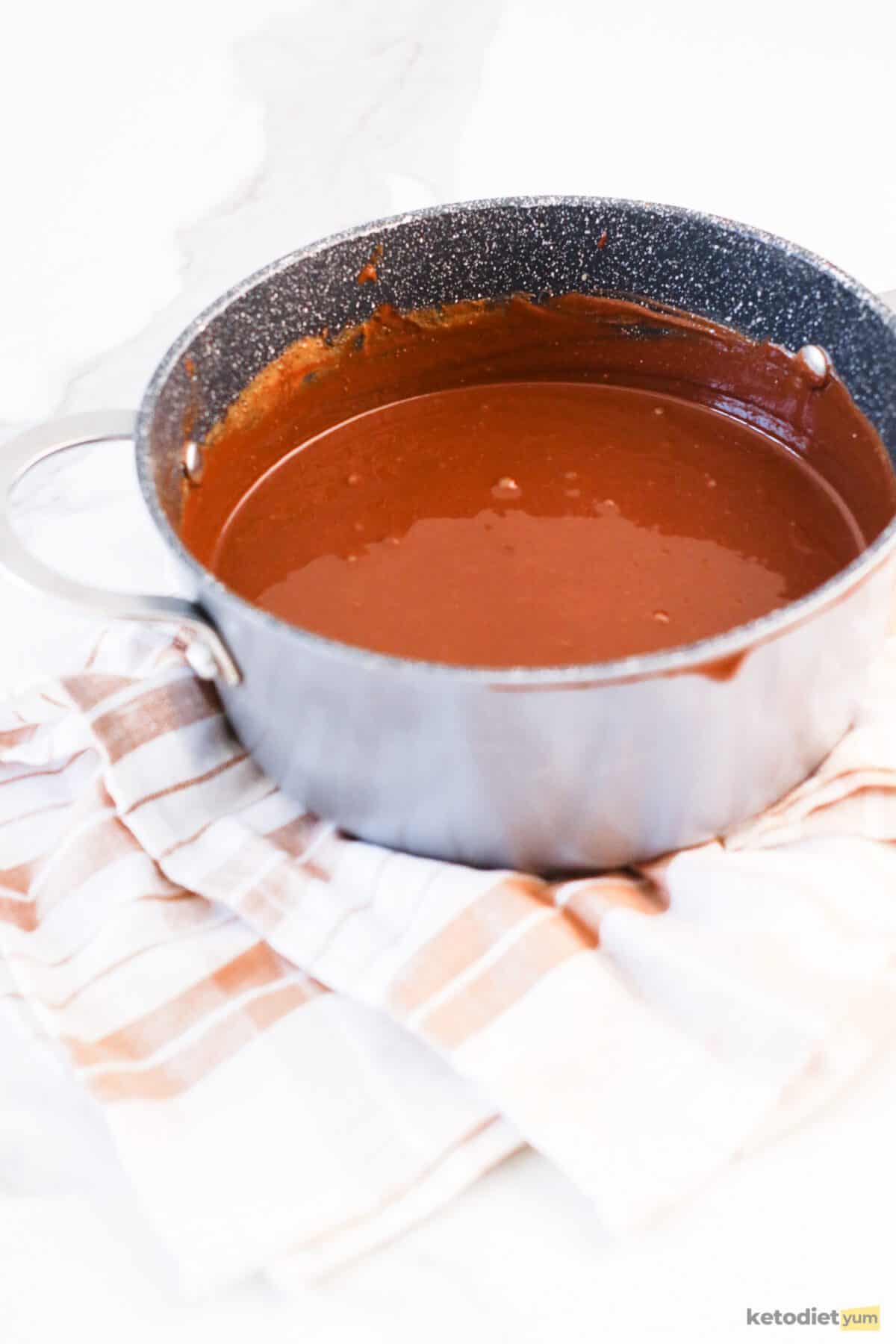 Keto Chocolate Peanut Butter Fudge Using a double boiler to melt sugar free chocolate chips and natural peanut butter into a fudge mixture ready to place in a lined loaf pan and set in the freezer