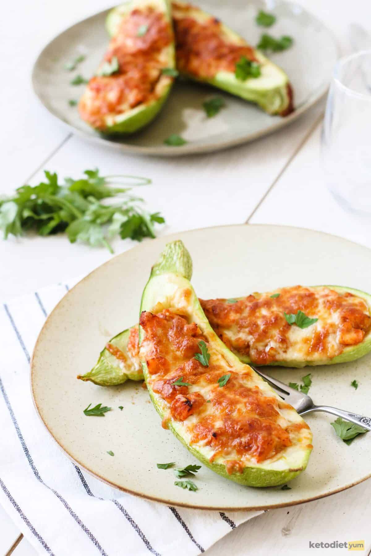 Delicious low carb salmon stuffed zucchini boats topped with a layer of golden mozzarella