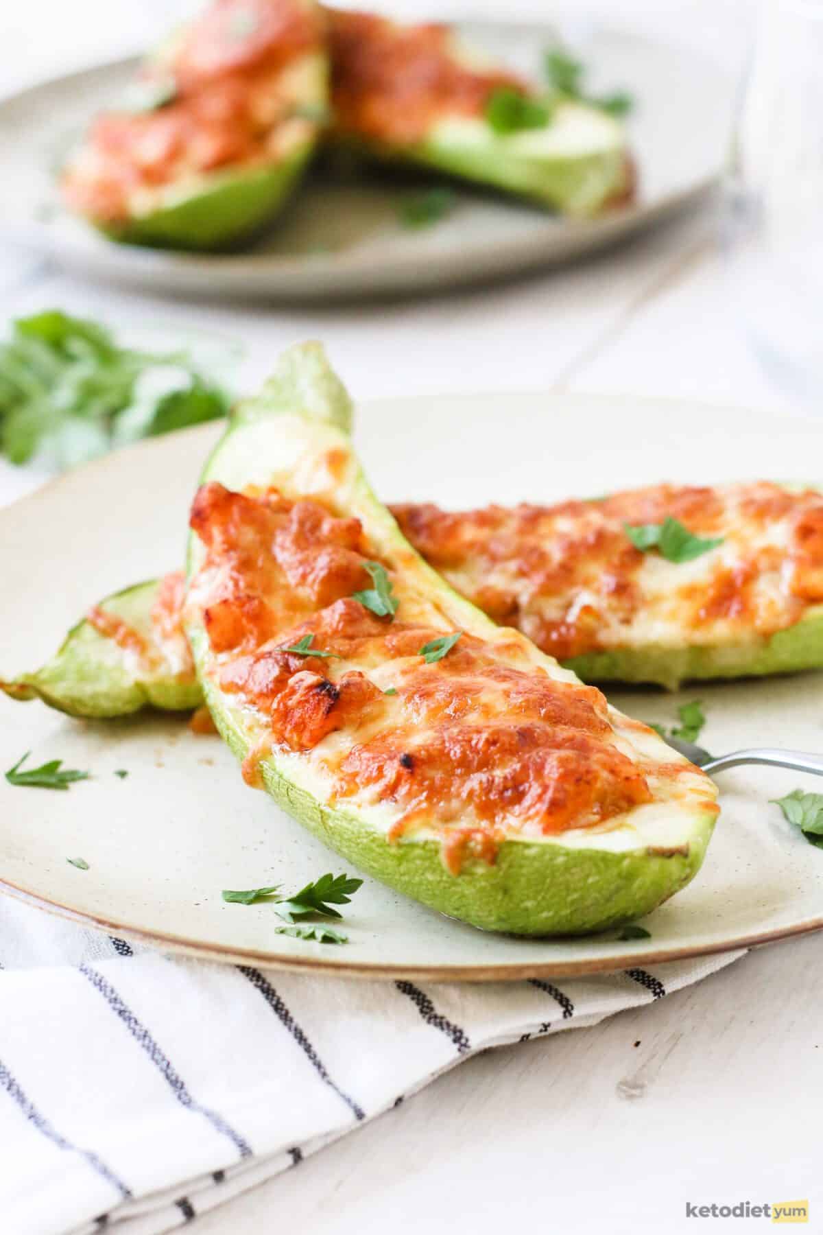 Delicious low carb salmon stuffed zucchini boats topped with a layer of golden mozzarella